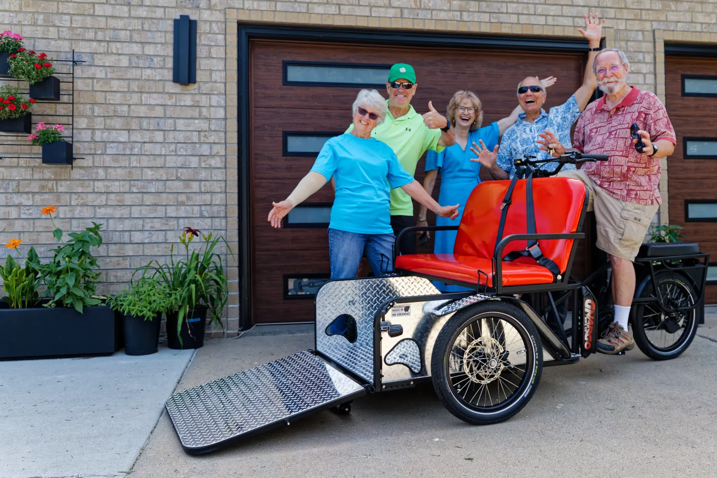 Volunteers and friends posing with the Cycling Without Age McFarland trishaw